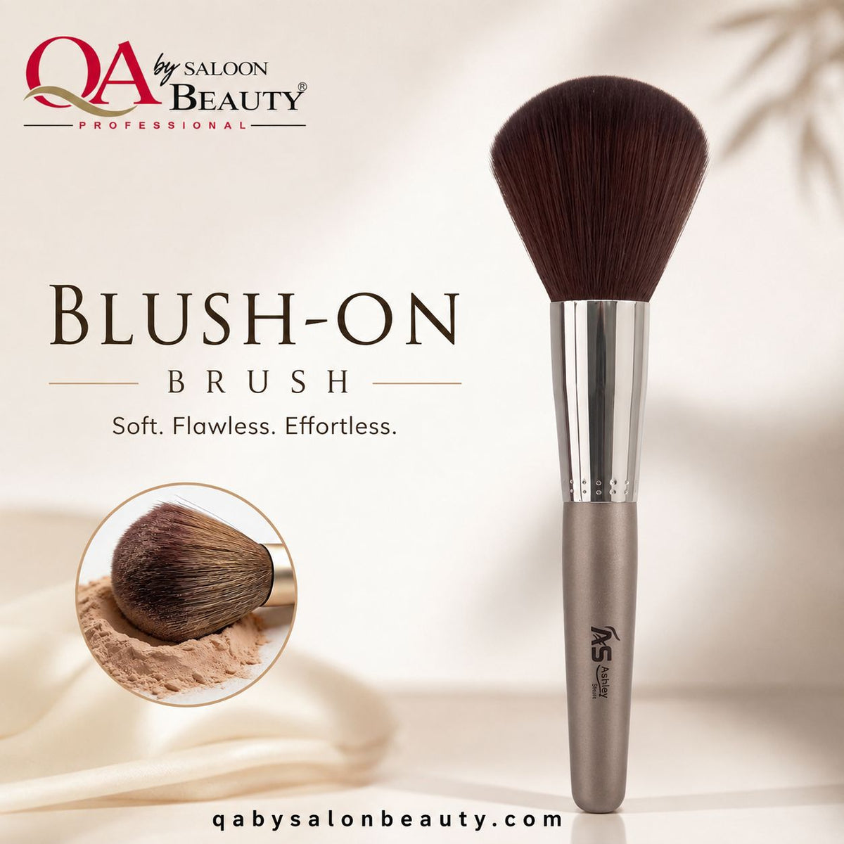 A professional makeup brush from QA by Saloon Beauty, labeled 'Blush-On Brush', featuring dark brown bristles, a silver ferrule, and a metallic taupe handle, set against a warm beige background with a circular inset showing the brush in use with powder.