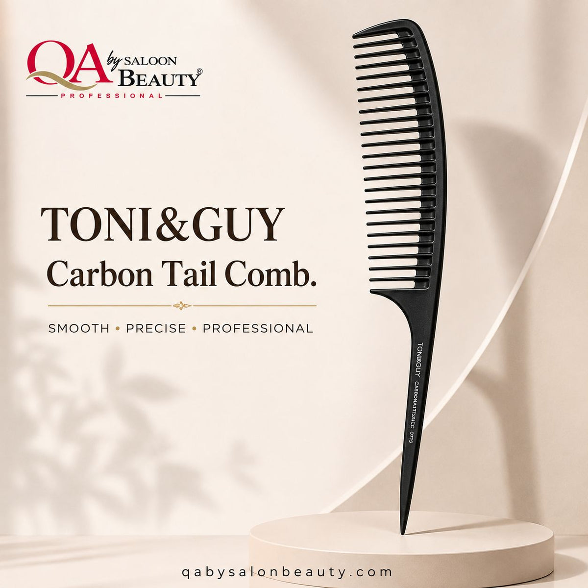 A black carbon tail comb from QA by Saloon Beauty is displayed on a beige pedestal against a warm beige background. The brand logo and text 'TONI&GUY Carbon Tail Comb.